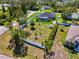 An aerial view shows a backyard, screened lanai with pool and storage shed at 1321 Calgary Rd, North Port, FL 34288