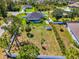 The manicured backyard includes a pool with screened lanai and white privacy fence at 1321 Calgary Rd, North Port, FL 34288