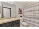 Bright bathroom featuring a vanity, toilet, shower with patterned curtain, and colorful dog art at 1321 Calgary Rd, North Port, FL 34288