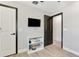 Cozy bedroom with dark trim, wood floors, a TV, and a convenient storage shelf at 1321 Calgary Rd, North Port, FL 34288