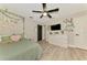 Charming bedroom with ceiling fan, TV, and decorative vines for a peaceful ambiance at 1321 Calgary Rd, North Port, FL 34288