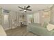 Serene bedroom with ivy accents, vanity, ceiling fan, and natural light from the window at 1321 Calgary Rd, North Port, FL 34288