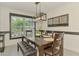 Bright dining room with modern lighting fixture and views of the outdoors at 1321 Calgary Rd, North Port, FL 34288