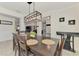 Dining room featuring a modern light fixture and open floor plan at 1321 Calgary Rd, North Port, FL 34288