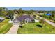 A charming home boasts a manicured lawn, gray exterior, and attached two-car garage at 1321 Calgary Rd, North Port, FL 34288