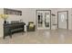 Stylish foyer featuring tile flooring, a black piano, and decorative accents, creating an inviting and elegant entrance to the home at 1321 Calgary Rd, North Port, FL 34288