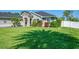 Charming single-story home featuring a stone facade, lush landscaping, and a well-manicured lawn at 1321 Calgary Rd, North Port, FL 34288
