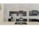 Modern kitchen boasting black cabinets, stainless steel appliances, and white subway tile backsplash at 1321 Calgary Rd, North Port, FL 34288