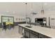 Spacious kitchen island with stainless steel sink and open living area at 1321 Calgary Rd, North Port, FL 34288