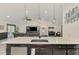 Kitchen island with white countertop, stainless steel dishwasher, and dark cabinetry at 1321 Calgary Rd, North Port, FL 34288