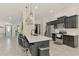 Modern kitchen featuring a white countertop island with seating and stainless steel appliances at 1321 Calgary Rd, North Port, FL 34288
