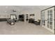 Spacious living room featuring tile flooring, a piano, and seamless flow with the modern interior design at 1321 Calgary Rd, North Port, FL 34288