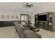 Inviting living room with large sectional, built-in entertainment center, and access to the outdoor patio at 1321 Calgary Rd, North Port, FL 34288