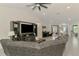 Open-concept living room featuring tile floors, a ceiling fan, piano, and seamless flow into the entryway at 1321 Calgary Rd, North Port, FL 34288