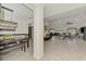 Bright and open living space featuring tile floors, seamlessly connecting the dining, kitchen, and living areas, perfect for entertaining at 1321 Calgary Rd, North Port, FL 34288