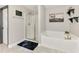 Ensuite bathroom with shower and soaking tub combo with grey tile floors and a dark accent wall at 1321 Calgary Rd, North Port, FL 34288