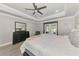 A spacious main bedroom with wood floors, tray ceiling and sliding glass door leading to outdoor space at 1321 Calgary Rd, North Port, FL 34288