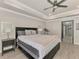 Bright main bedroom featuring wood floors, a ceiling fan, and access to the ensuite bathroom and a treadmill at 1321 Calgary Rd, North Port, FL 34288