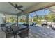 Inviting screened lanai with a large table, outdoor furniture, and a peaceful view of the backyard and pool at 1321 Calgary Rd, North Port, FL 34288