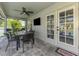Covered patio featuring outdoor seating, ceiling fan, and views of the screened-in pool at 1321 Calgary Rd, North Port, FL 34288