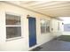 Rear entryway showing a bright blue front door and shaded porch at 139 Dow Rd, Port Charlotte, FL 33952