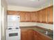 Efficient kitchen with white appliances and wood cabinets offering ample storage at 139 Dow Rd, Port Charlotte, FL 33952