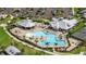 An aerial view of a community pool with lounge seating and tropical landscaping at 14271 Heritage Landing Blvd # 1516, Punta Gorda, FL 33955