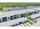 Beautiful condo complex with lake view, lush landscaping, and white tile roof at 14271 Heritage Landing Blvd # 1516, Punta Gorda, FL 33955