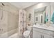 Bathroom featuring a shower and tub, white vanity, and nautical-themed decor at 14271 Heritage Landing Blvd # 1516, Punta Gorda, FL 33955