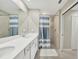 Bright bathroom with double sinks, and a tiled walk-in shower showcasing modern neutral design elements at 14271 Heritage Landing Blvd # 1516, Punta Gorda, FL 33955