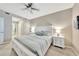 Comfortable bedroom with a ceiling fan, en-suite bathroom access, and bright, neutral color palette at 14271 Heritage Landing Blvd # 1516, Punta Gorda, FL 33955