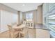 Inviting dining area with white table and chairs, storage, and a serene window view at 14271 Heritage Landing Blvd # 1516, Punta Gorda, FL 33955
