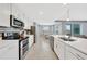 Modern, all-white kitchen with stainless steel appliances and lake views at 14271 Heritage Landing Blvd # 1516, Punta Gorda, FL 33955