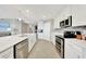 Modern, all-white kitchen with stainless steel appliances, ample counter space and an open concept at 14271 Heritage Landing Blvd # 1516, Punta Gorda, FL 33955