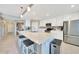 Spacious kitchen boasts white cabinetry, stainless appliances, granite countertops, and an island with seating for two at 14271 Heritage Landing Blvd # 1516, Punta Gorda, FL 33955