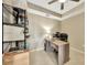Well-lit home office area with tile flooring, tray ceiling, workspace, and shelving storage at 14271 Heritage Landing Blvd # 1516, Punta Gorda, FL 33955
