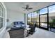 Relaxing patio with wicker furniture, ceiling fan, and screened views of the outdoors at 14271 Heritage Landing Blvd # 1516, Punta Gorda, FL 33955