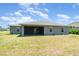 The backyard features a covered patio and ample green space for outdoor activities and relaxation at 16031 Hesta Misty Ct, Punta Gorda, FL 33955