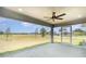 Relaxing enclosed patio with ceiling fan, recessed lighting, and views of the expansive backyard and neighborhood at 16031 Hesta Misty Ct, Punta Gorda, FL 33955