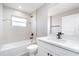 Bright bathroom features a bathtub, modern vanity, and sleek black fixtures at 16098 Overdale Ct, Punta Gorda, FL 33955