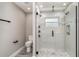 Updated bathroom featuring glass shower with modern fixtures, white tile, and toilet at 16098 Overdale Ct, Punta Gorda, FL 33955