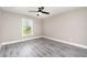 Light-filled bedroom with a ceiling fan, natural light, and neutral gray walls at 16098 Overdale Ct, Punta Gorda, FL 33955