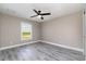Bedroom features natural light, modern ceiling fan, and neutral gray color scheme at 16098 Overdale Ct, Punta Gorda, FL 33955