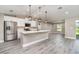 Kitchen featuring stainless steel appliances, white cabinets, and an island with pendant lighting at 16098 Overdale Ct, Punta Gorda, FL 33955
