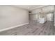 Open-concept living area with gray flooring seamlessly connecting the kitchen and living room spaces at 16098 Overdale Ct, Punta Gorda, FL 33955
