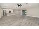 Open-concept living space with modern gray flooring, a ceiling fan, and sliding glass doors at 16098 Overdale Ct, Punta Gorda, FL 33955