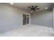 A covered patio area with concrete floor and ceiling fan with view to interior at 16098 Overdale Ct, Punta Gorda, FL 33955
