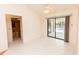 Bedroom featuring white tile flooring, a ceiling fan and a glass sliding door leading to a screened-in pool at 1612 Blue Lake Cir, Punta Gorda, FL 33983