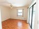 Bedroom featuring light walls, wood flooring, fan, and sliding glass doors at 1612 Blue Lake Cir, Punta Gorda, FL 33983