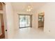 Dining room with sliding glass doors opening to the pool and a view of the kitchen, all under a fan at 1612 Blue Lake Cir, Punta Gorda, FL 33983